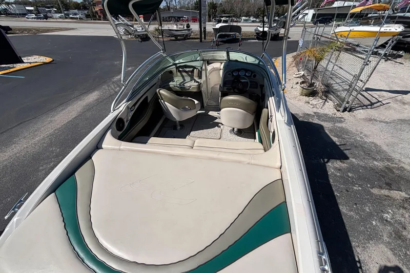 Slide: The Image of 2005 Sea Ray 220 Select boat interior with seating and dashboard, parked outdoors. - 8