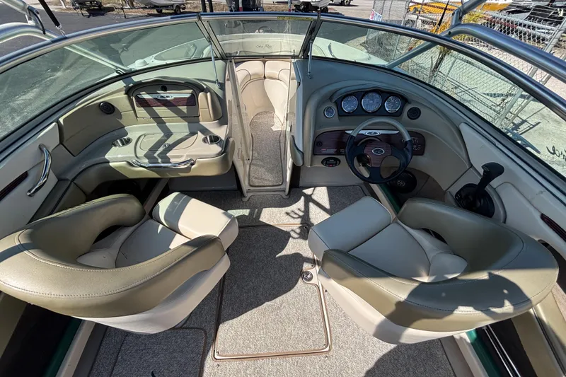 Slide: The Image of Interior of a 2005 Sea Ray 220 Select boat with beige seating and dashboard. - 9