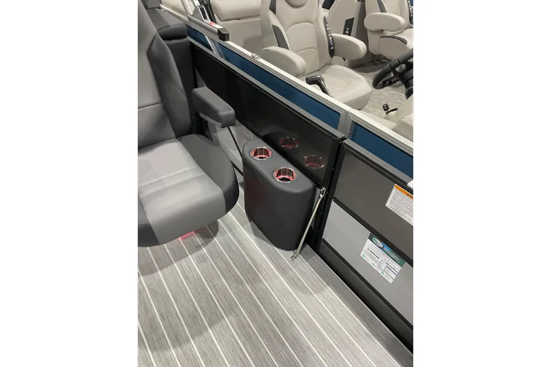 Slide: The Image of 2025 Trifecta 23RFSS boat interior with gray seating and cup holders. - 14
