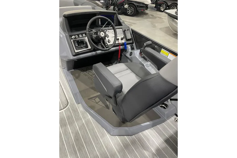 Slide: The Image of 2025 Trifecta 23RFSS boat helm with modern controls and comfortable seating. - 8