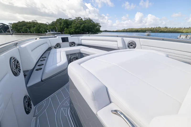 Slide: The Image of Luxurious 2026 Cigarette 42' Auroris boat interior with white seating and scenic water view. - 6