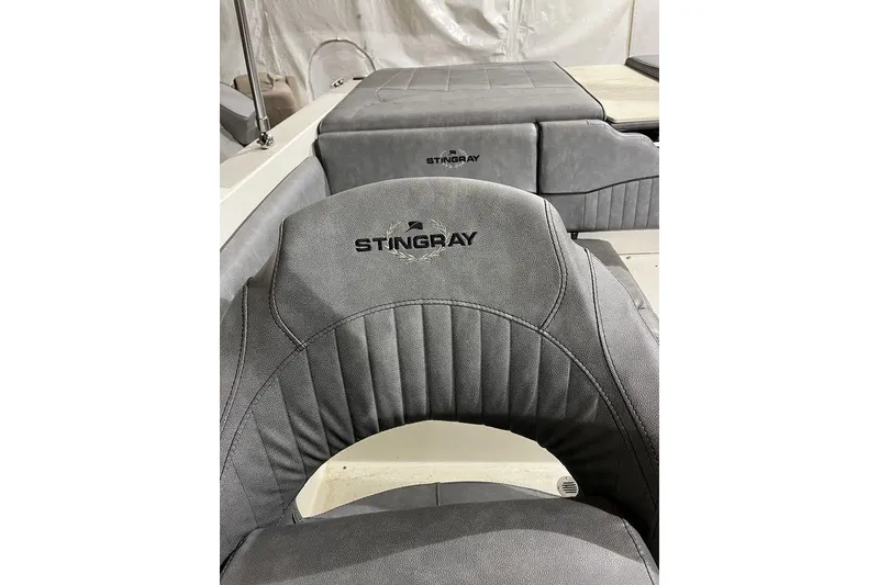 Slide: The Image of 2020 Stingray 208 CR boat interior with gray upholstered seating. - 10