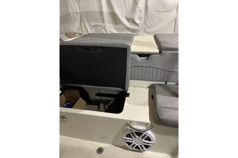 Slide: The Image of 2020 Stingray 208 CR boat interior with open storage compartment and speaker. - 12