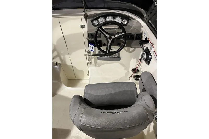 Slide: The Image of 2020 Stingray 208 CR boat cockpit with steering wheel and gauges. - 16