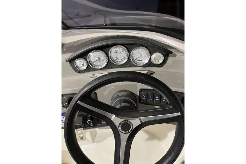 Slide: The Image of Steering wheel and dashboard of 2020 Stingray 208 CR boat, featuring multiple gauges. - 18