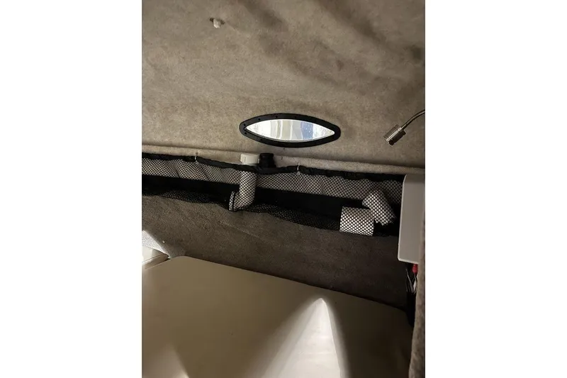 Slide: The Image of Interior cabin of 2020 Stingray 208 CR boat with storage net and light. - 19