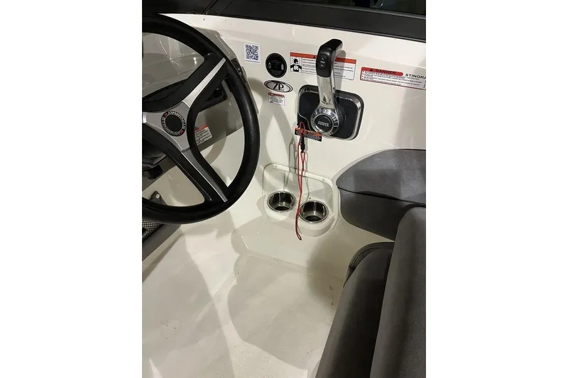 Slide: The Image of 2020 Stingray 208 CR boat interior with steering wheel and control panel. - 20