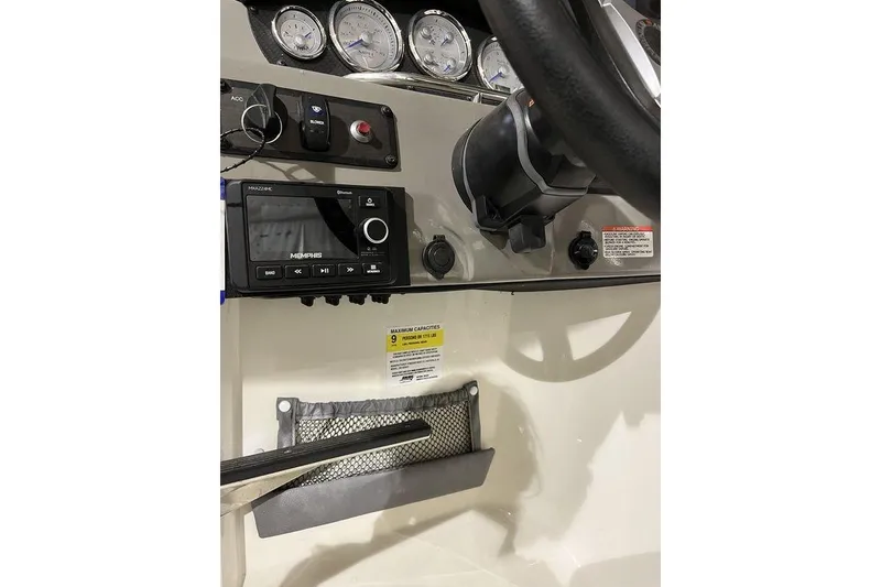 Slide: The Image of Dashboard of 2020 Stingray 208 CR boat with gauges and audio system. - 22