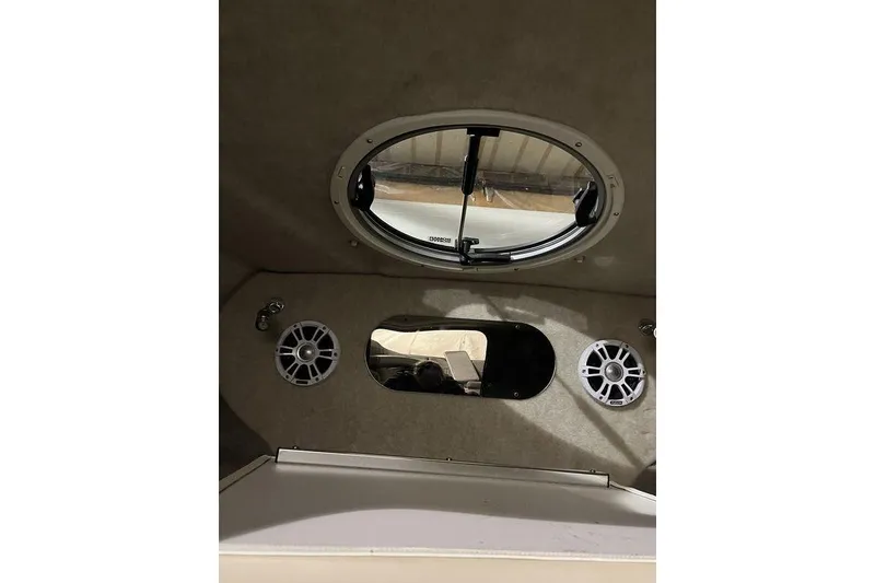 Slide: The Image of Interior view of 2020 Stingray 208 CR boat with speakers and porthole window. - 23