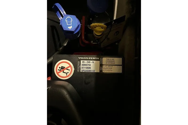 Slide: The Image of Engine compartment of 2020 Stingray 208 CR with Volvo Penta components and warning label. - 25