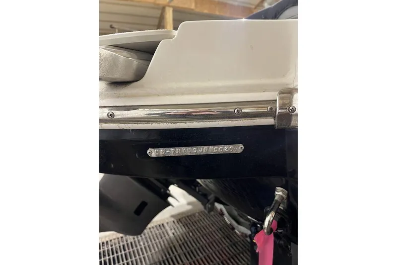 Slide: The Image of 2020 Stingray 208 CR boat hull detail with identification plate in a garage setting. - 27
