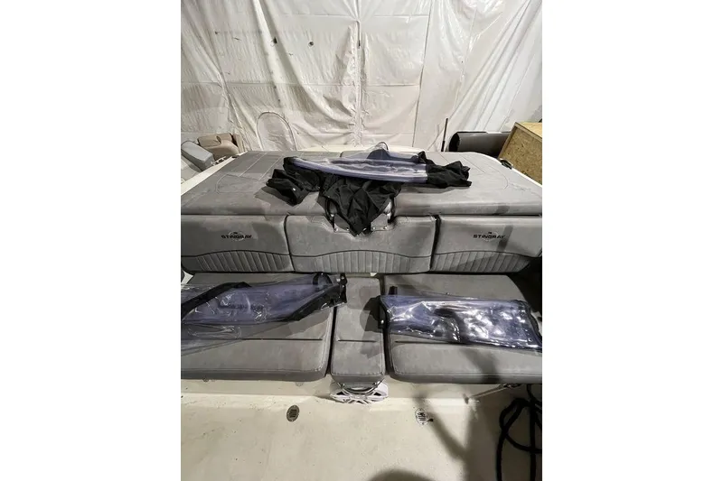 Slide: The Image of 2020 Stingray 208 CR boat interior with gray seating and protective covers. - 6