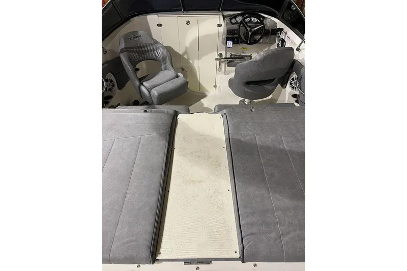 Slide: The Image of 2020 Stingray 208 CR boat interior with gray seating and steering console. - 7