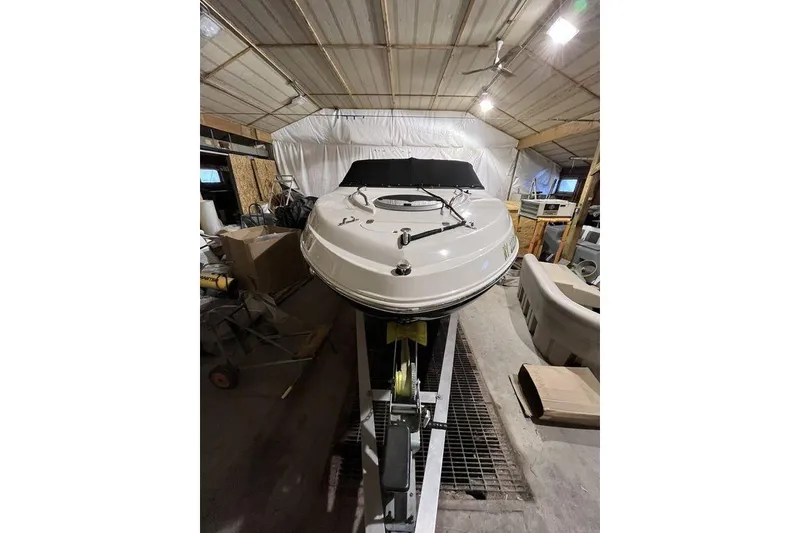 Slide: The Image of 2020 Stingray 208 CR boat in storage, front view, indoor setting. - 8