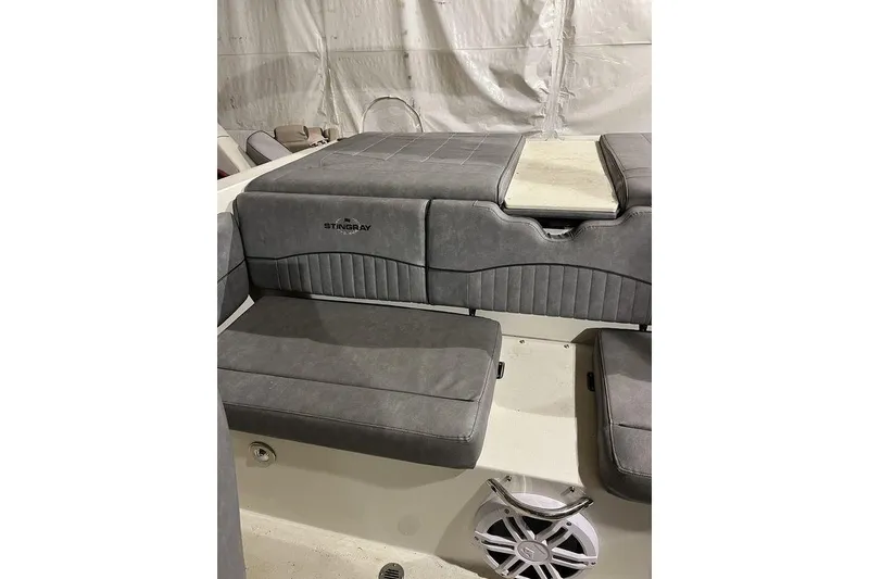 Slide: The Image of 2020 Stingray 208 CR boat interior with gray cushioned seating and speaker. - 9