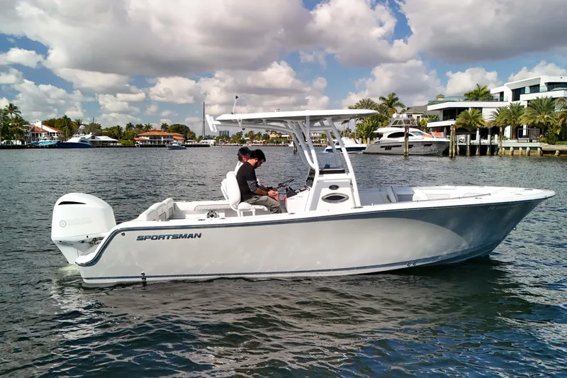 Slide: The Image of 2018 Sportsman Heritage 241 Center Console boat on water, with scenic waterfront background. - 10