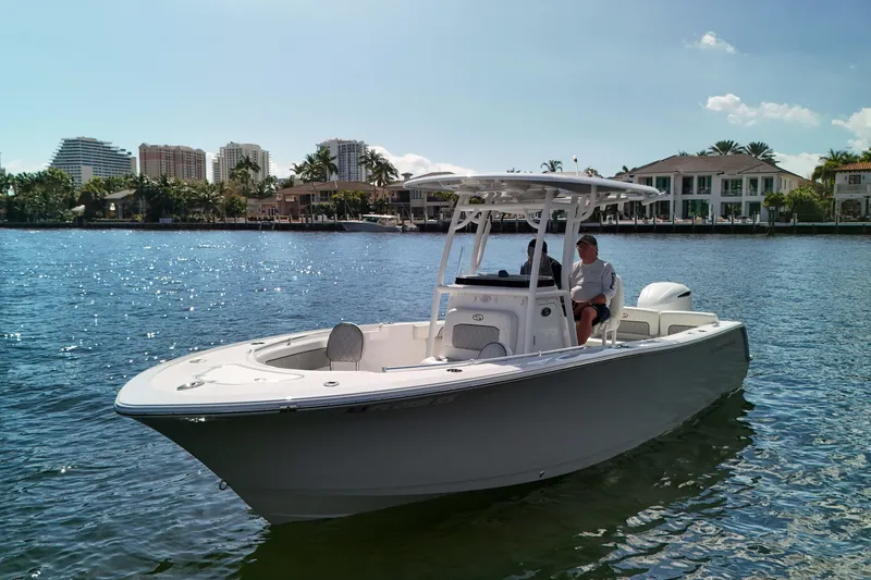 Slide: The Image of 2018 Sportsman Heritage 241 Center Console boat on water, with waterfront homes in background. - 11