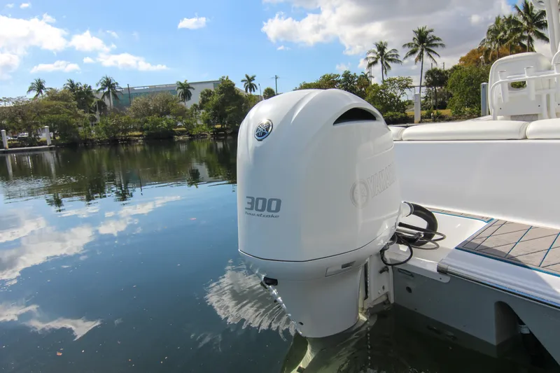 Slide: The Image of 2018 Sportsman Heritage 241 Center Console with Yamaha 300 outboard engine on calm water. - 15