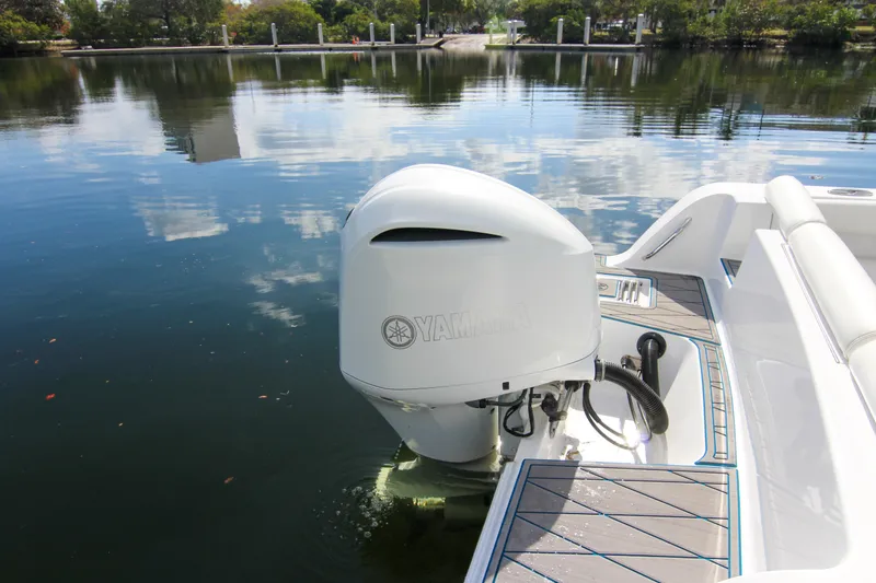 Slide: The Image of 2018 Sportsman Heritage 241 Center Console with Yamaha outboard on calm water. - 16