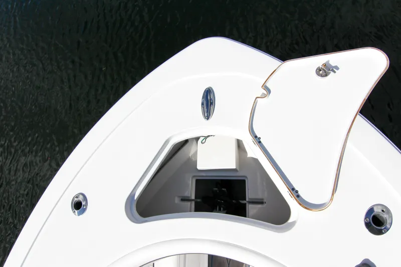 Slide: The Image of 2018 Sportsman Heritage 241 Center Console boat bow with open hatch, on water. - 24