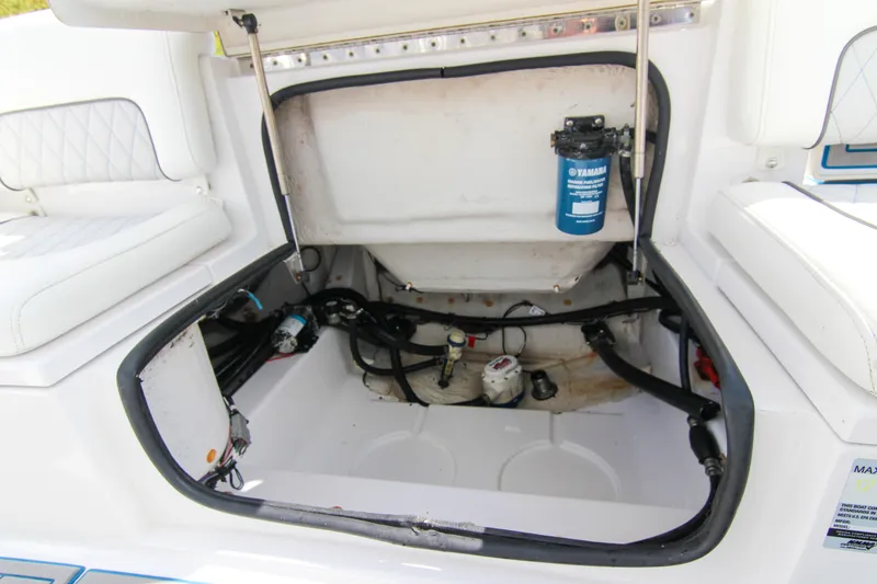 Slide: The Image of Open storage compartment of 2018 Sportsman Heritage 241 Center Console boat, showing internal components. - 29