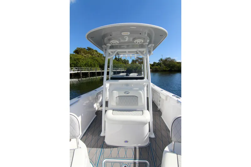 Slide: The Image of 2018 Sportsman Heritage 241 Center Console boat on a sunny day, near a riverbank. - 33