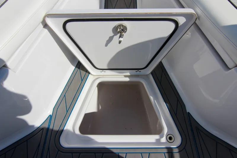 Slide: The Image of Open storage compartment on 2018 Sportsman Heritage 241 Center Console boat. - 40