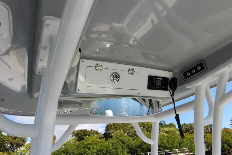 Slide: The Image of 2018 Sportsman Heritage 241 Center Console boat interior with control panel and storage. - 43