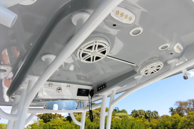 Slide: The Image of 2018 Sportsman Heritage 241 Center Console boat's overhead console with speakers and controls. - 44