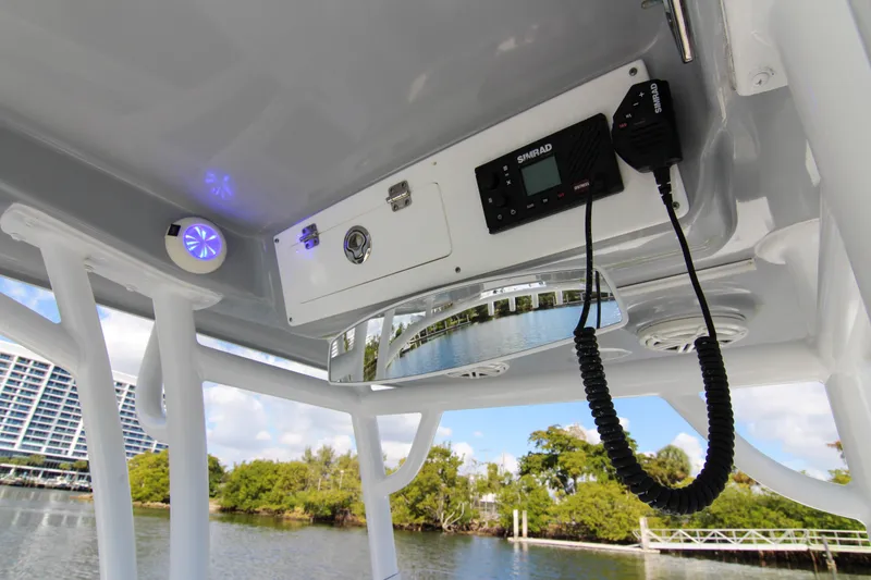 Slide: The Image of 2018 Sportsman Heritage 241 Center Console boat interior with radio and speaker system. - 47