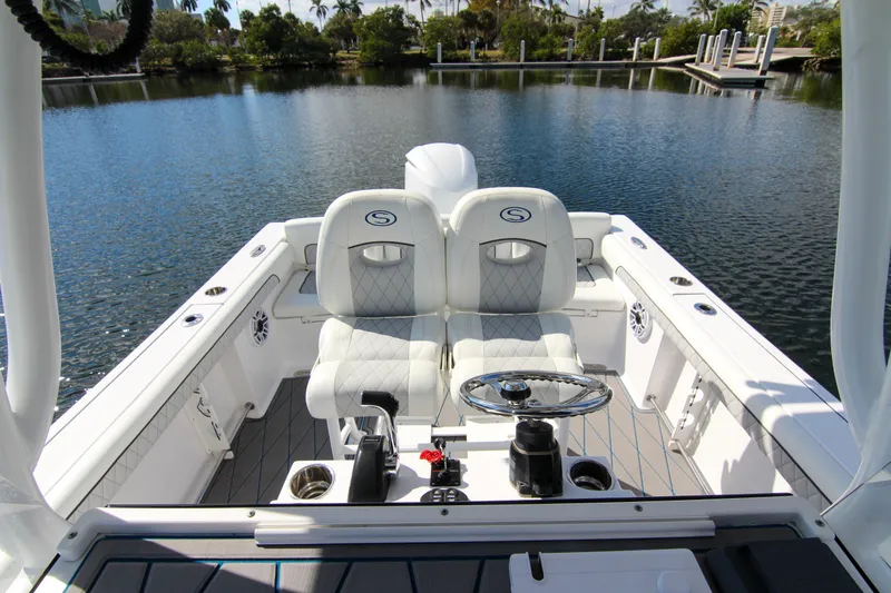 Slide: The Image of 2018 Sportsman Heritage 241 Center Console boat interior with steering wheel and seating. - 50