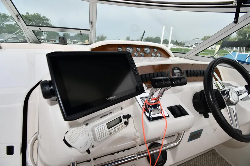 Slide: The Image of 1995 Sea Ray 330 Sundancer helm with Garmin display and controls. - 12
