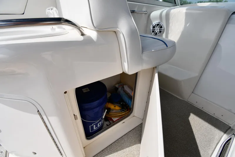 Slide: The Image of 1995 Sea Ray 330 Sundancer interior storage compartment with bucket and supplies. - 26