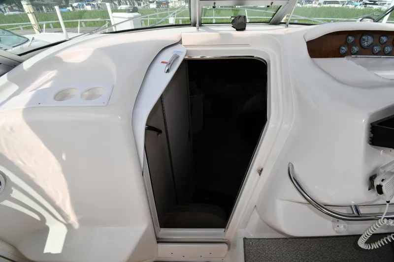 Slide: The Image of 1995 Sea Ray 330 Sundancer cabin entrance with dashboard and cup holders. - 30