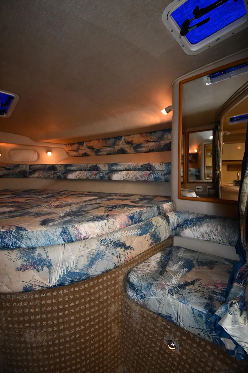 Slide: The Image of Interior cabin of 1995 Sea Ray 330 Sundancer with patterned upholstery and cozy lighting. - 32