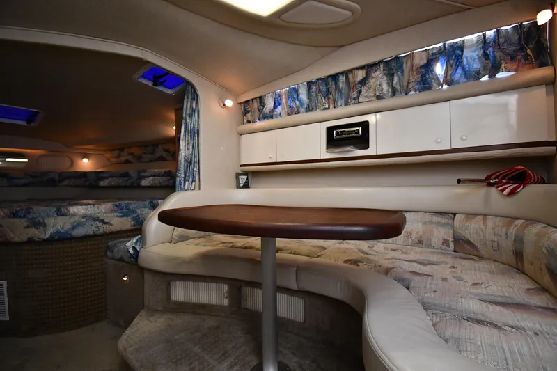 Slide: The Image of Interior of 1995 Sea Ray 330 Sundancer with cozy seating and wooden table. - 36