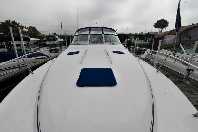 Slide: The Image of 1995 Sea Ray 330 Sundancer yacht docked, featuring a sleek white deck with blue accents. - 4