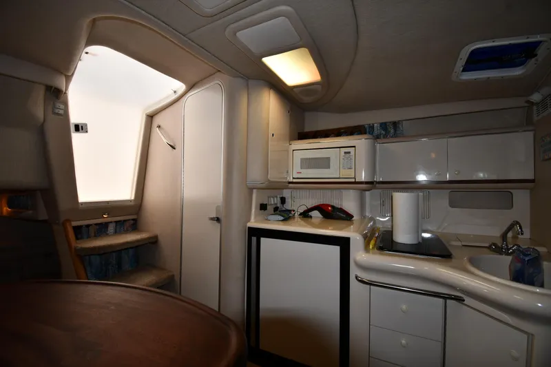 Slide: The Image of Interior of 1995 Sea Ray 330 Sundancer yacht with kitchenette and stairs. - 40