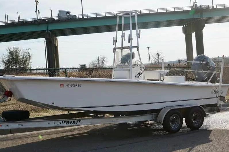 Slide: The Image of 2018 Intruder 23 boat on trailer under bridge, side view. - 11
