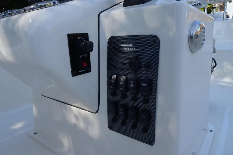 Slide: The Image of Control panel of a 2015 Pioneer 186 Cape Island boat with switches and dials. - 16