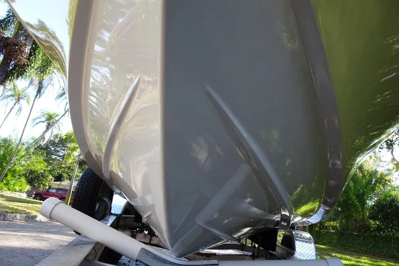 Slide: The Image of 2015 Pioneer 186 Cape Island boat hull on trailer, surrounded by tropical trees. - 6