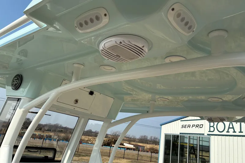 Slide: The Image of 2026 Sea Pro 245FLX Sandbar boat interior with speakers and lighting fixtures. - 13