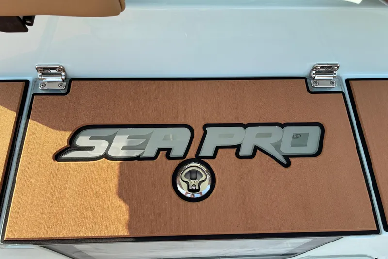 Slide: The Image of Sea Pro 245FLX Sandbar 2026 logo on boat deck with wood finish. - 15