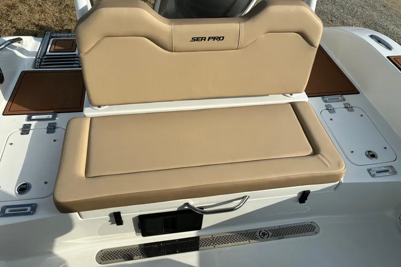 Slide: The Image of 2026 Sea Pro 245FLX Sandbar boat seat with tan upholstery and storage compartments. - 17