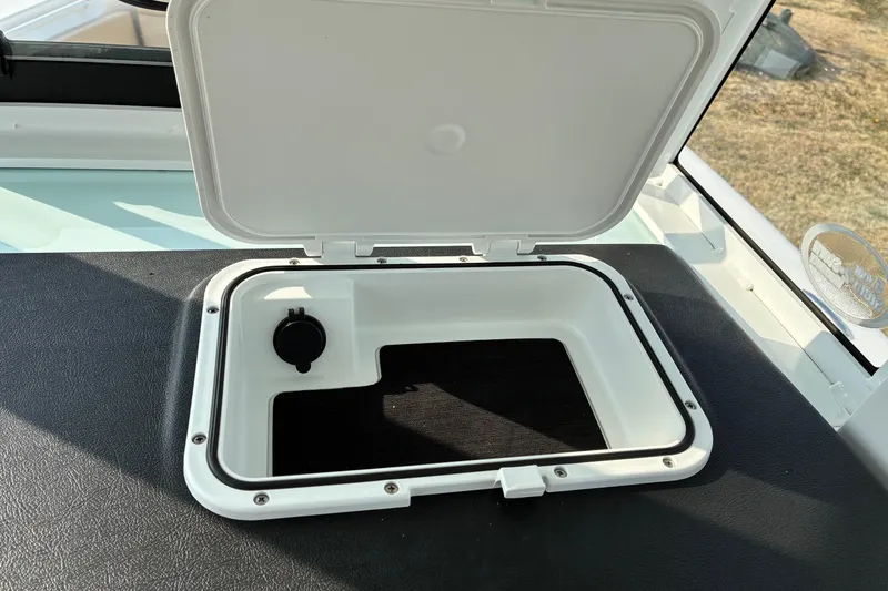 Slide: The Image of Open storage compartment on 2026 Sea Pro 245FLX Sandbar boat. - 20