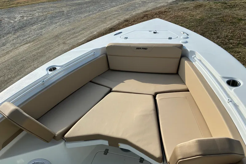 Slide: The Image of 2026 Sea Pro 245FLX Sandbar boat with beige cushioned seating and cup holders. - 21