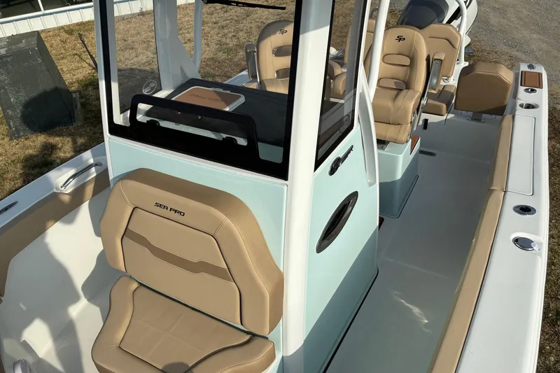 Slide: The Image of 2026 Sea Pro 245FLX Sandbar boat interior with tan seating and modern design. - 24