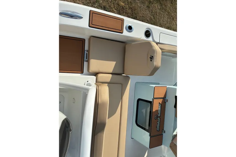 Slide: The Image of 2026 Sea Pro 245FLX Sandbar boat interior with tan seating and storage compartments. - 25