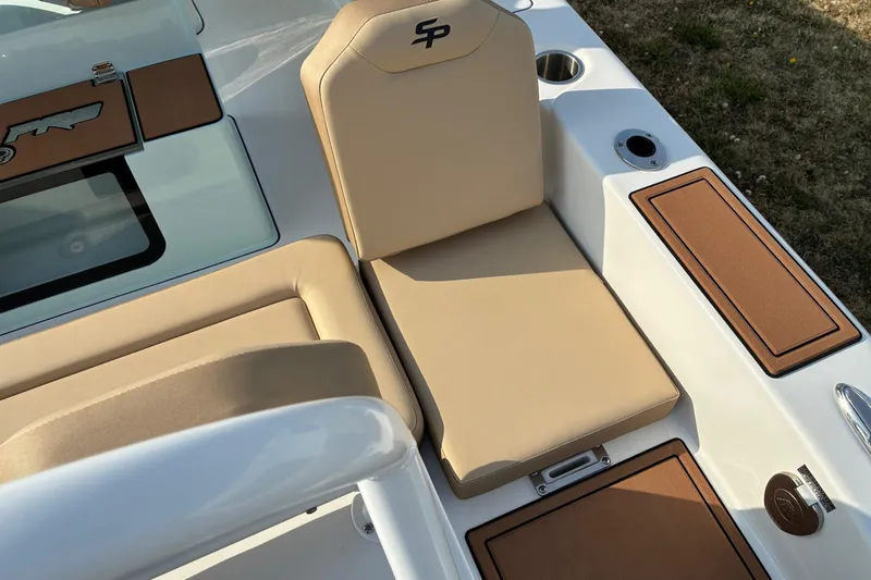 Slide: The Image of 2026 Sea Pro 245FLX Sandbar boat interior with beige seating and brown accents. - 26