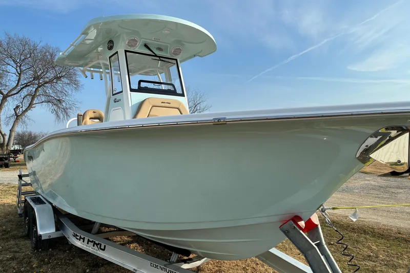 Slide: The Image of 2026 Sea Pro 245FLX Sandbar boat on trailer, side view under clear sky. - 3